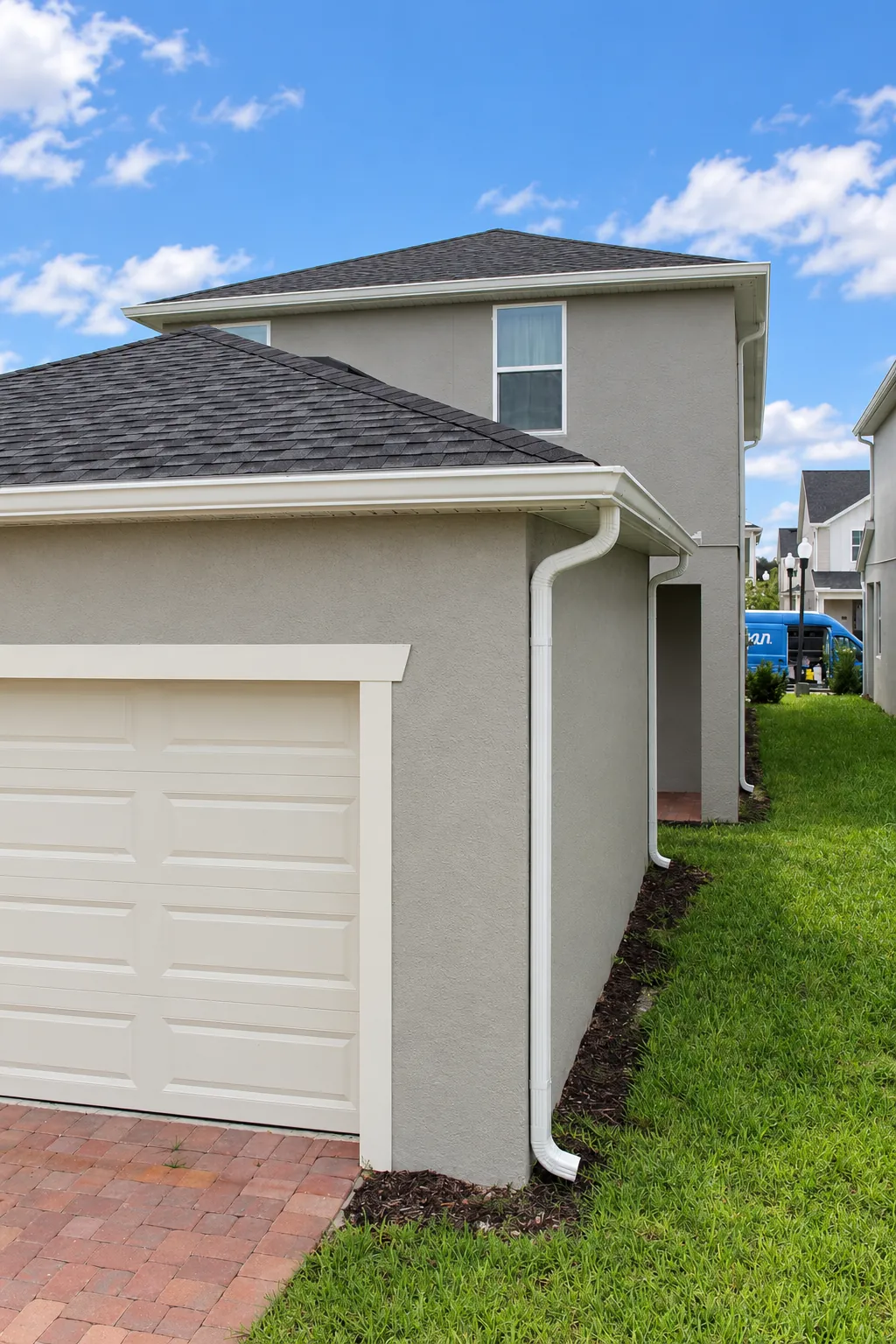 White gutters and downspout by the garage of a two-story home in Apopka, FL