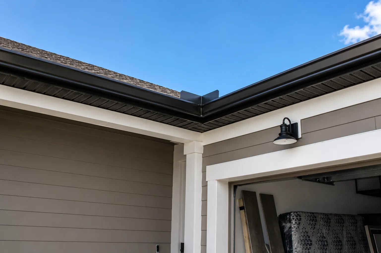 Dark bronze seamless gutter corner over a garage in Central Florida