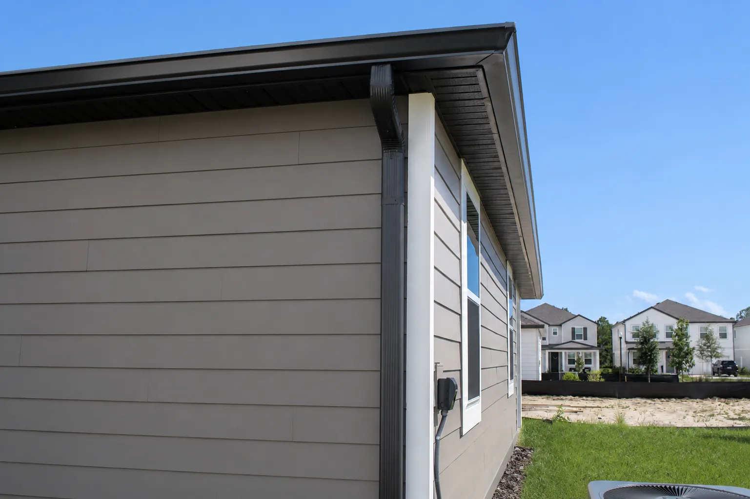 Dark bronze gutter and downspout on a new home in Central Florida