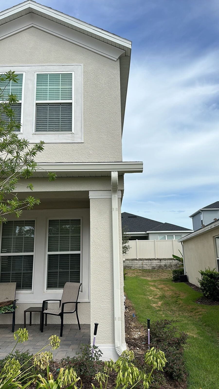 Downspout on a two-story stucco home in Central Florida