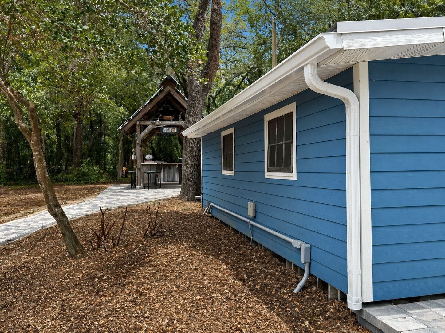 White gutter and downspout on a blue-sided home in Central Florida