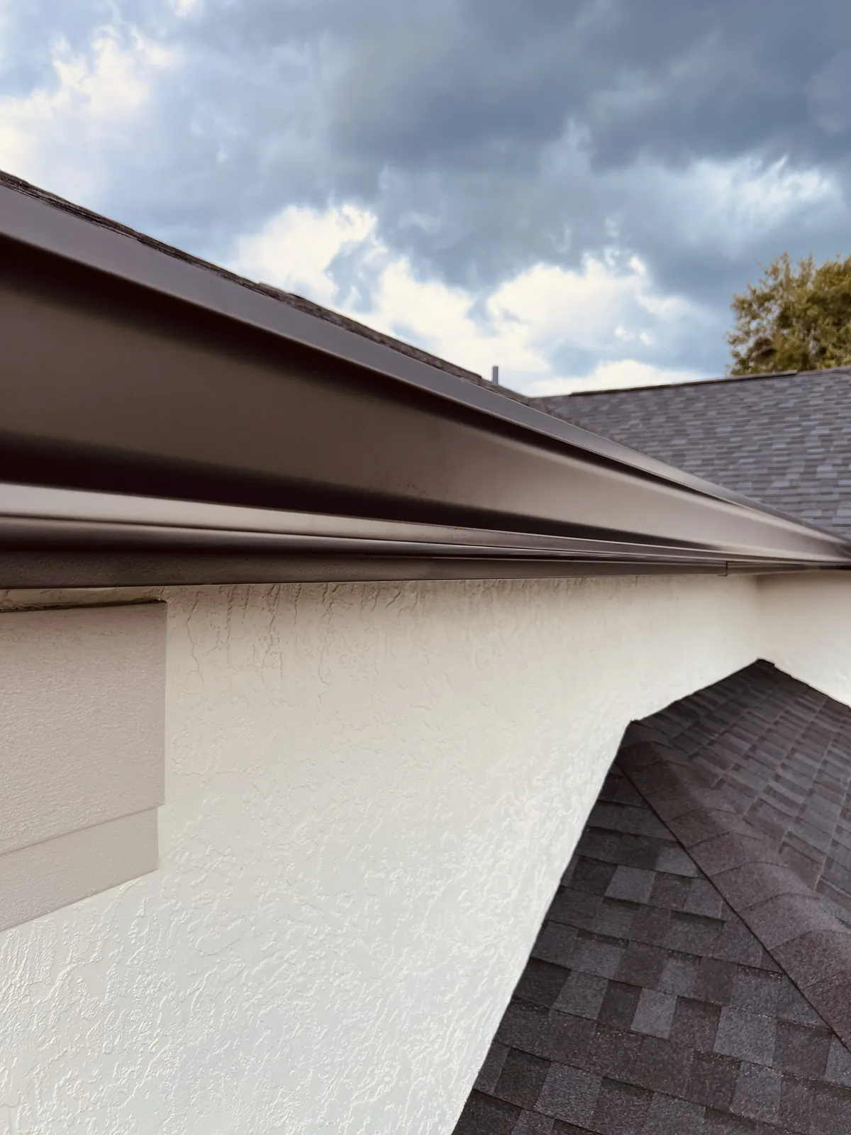 Close-up of a new seamless gutter under the roof edge in Oviedo, FL
