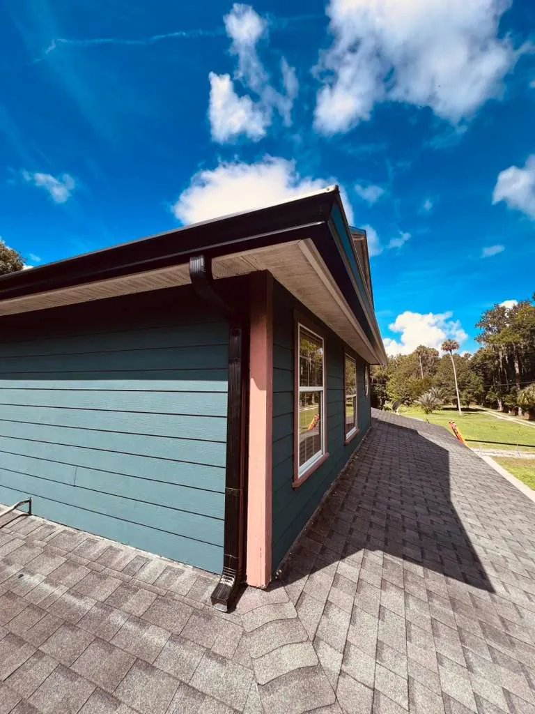 Seamless gutters and downspout on a teal-sided home in Oviedo, FL