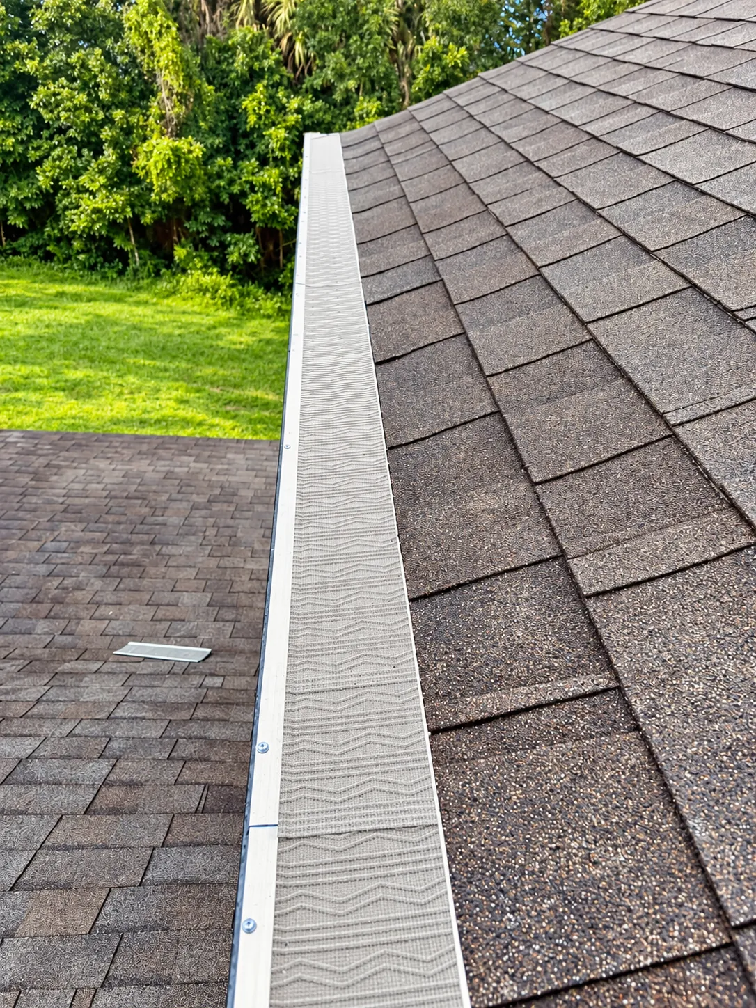 Micro-mesh gutter guard installed on a shingle roof in Oviedo, FL