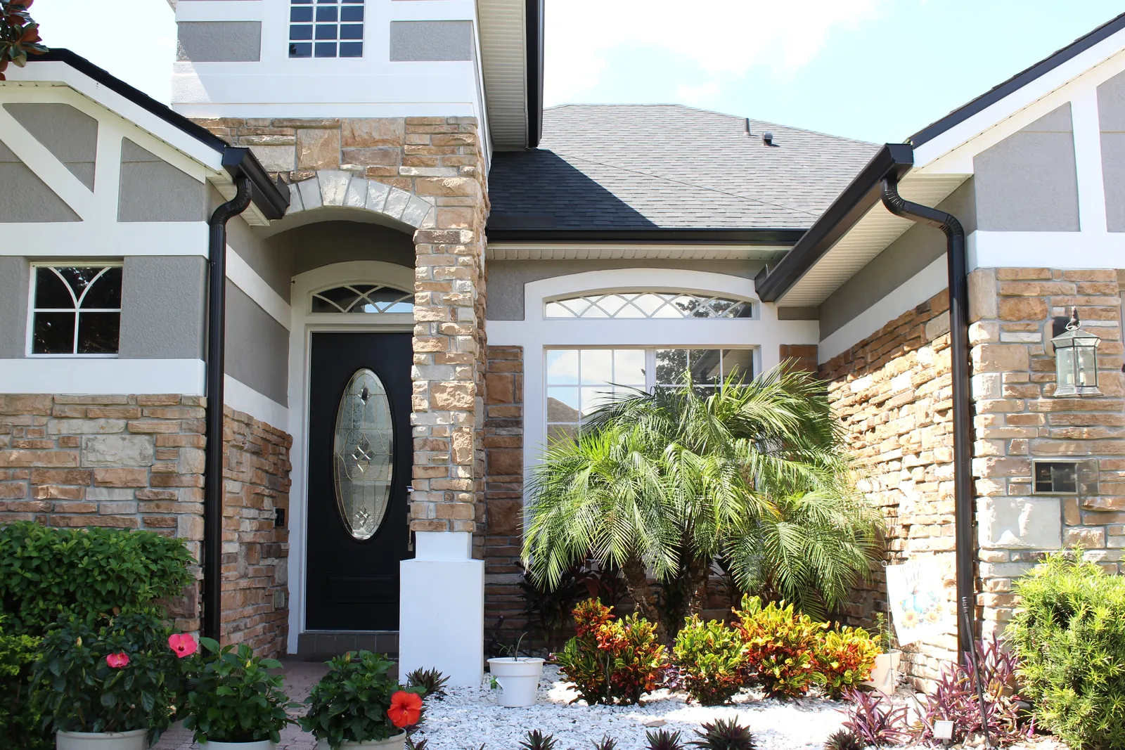 Seamless gutters framing the front entry of a home in Sanford, FL